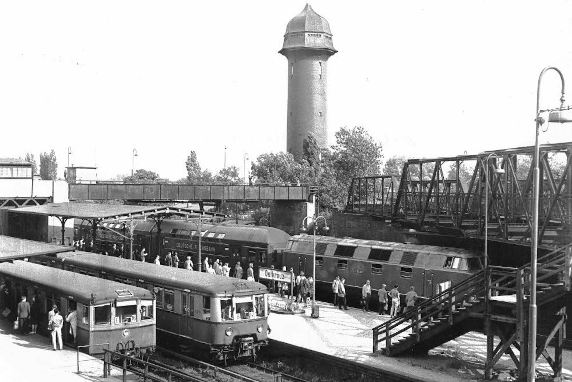 Viel Betrieb 1964: zwei S-Bahnen und ein Zug vor der Kulisse des Wasserturms am Ostkreuz. Der Knotenpunkt in Friedrichshain gilt auch heute als einer der wichtigsten S-Bahnhöfe in Berlin.