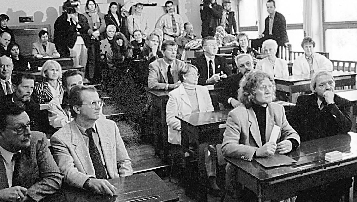 Klassentreffen: Die Schüler von einst sitzen 1996 auf ihren alten Plätzen im „Stufenraum“, wo sie 1956 ihre ersten Schweigeminuten einlegten. 