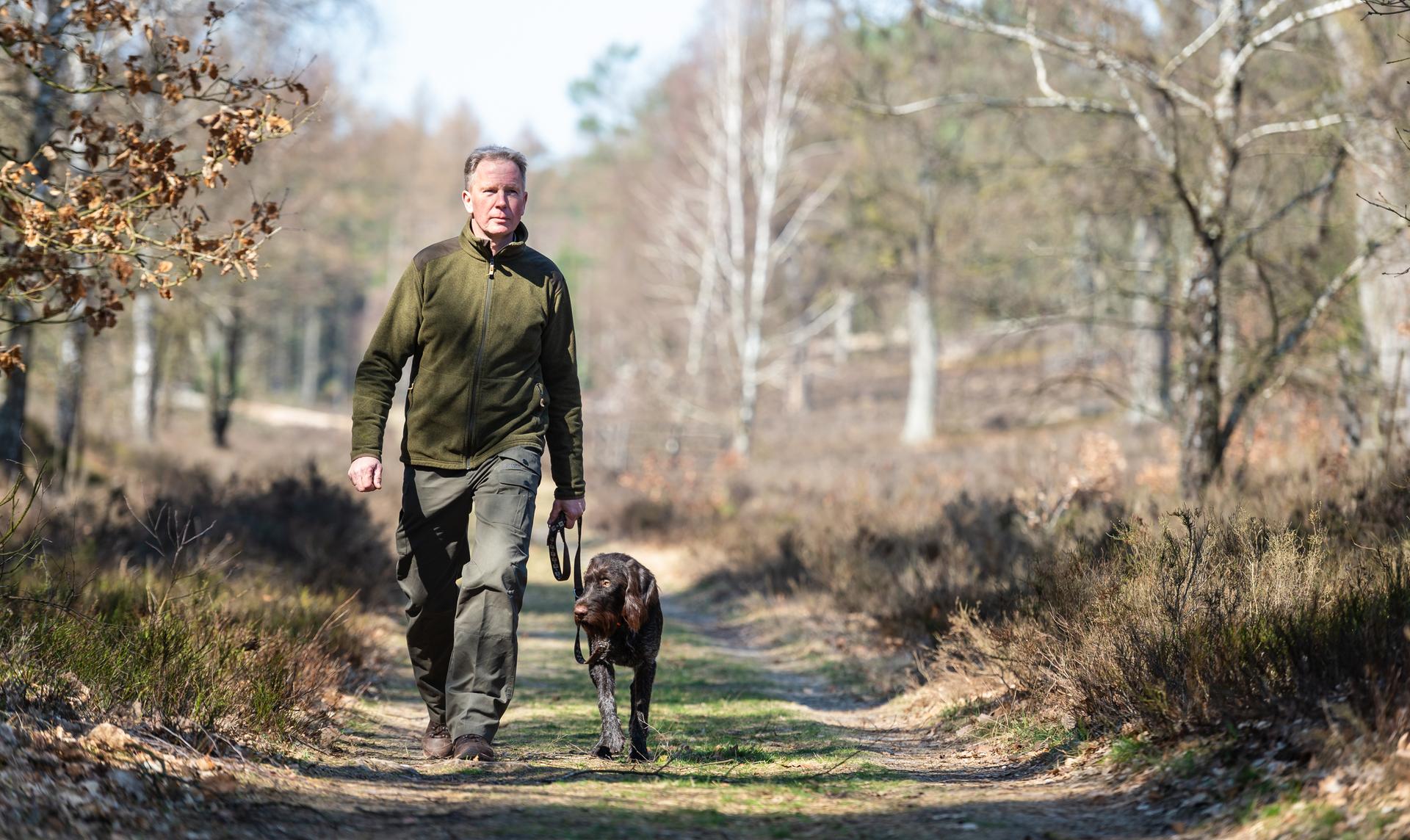 Peter Pabel, Experte für Mufflons, Wolfsberater und von Beruf Förster, geht in der Göhrde mit seinem Hund Anouk spazieren.