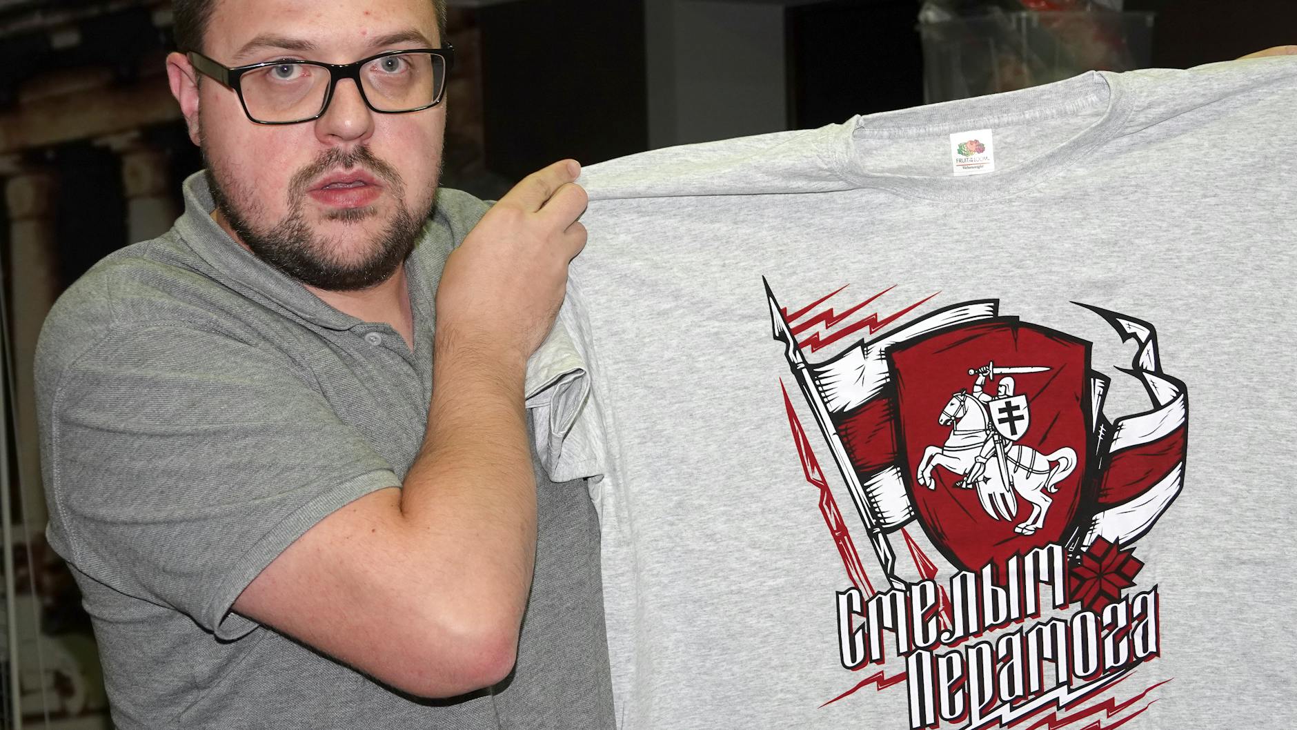  Pawel Belous hält ein T-Shirt mit dem alten belarussischen Wappen, das die Aufschrift „Der Mutige siegt“ trägt. 