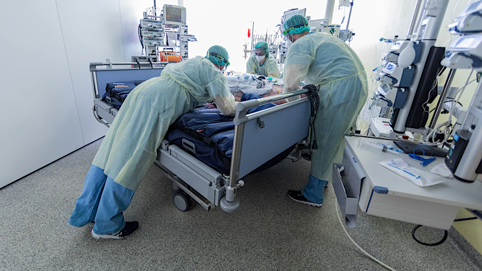 Intensivpflegekräfte transportieren einen beatmeten Corona-Patienten auf die Intensivstation.&nbsp;