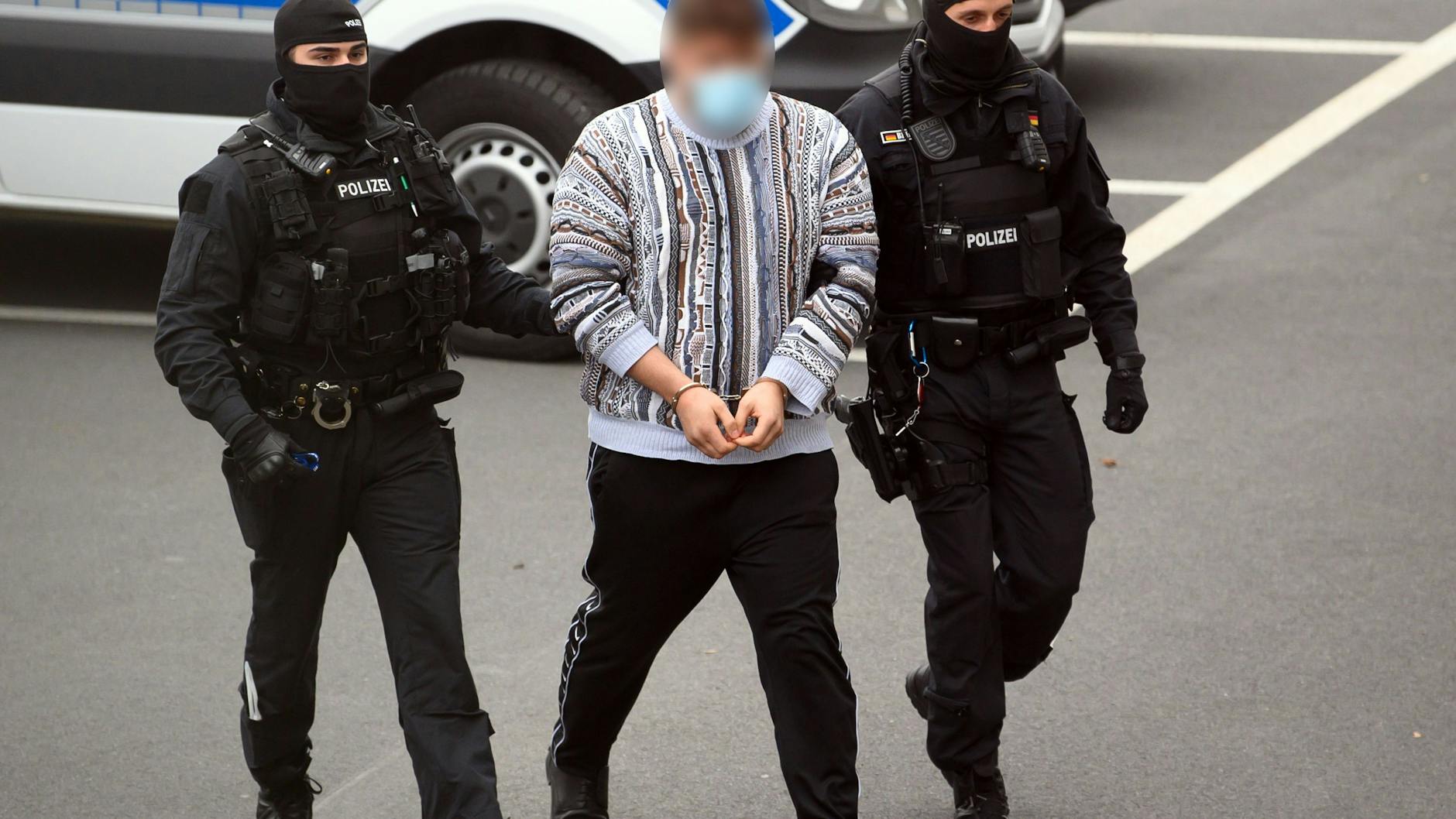 Perp walk: one of the three suspects is taken into a Dresden courthouse.