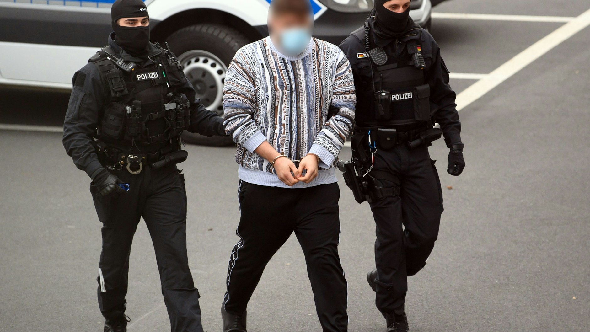 Perp walk: one of the three suspects is taken into a Dresden courthouse.