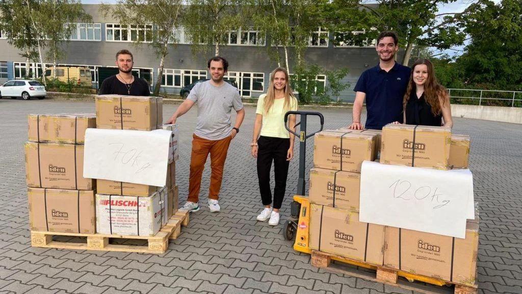 Aid Pioneers volunteers with a shipment ready for transport. Schmidt is in the yellow shirt.