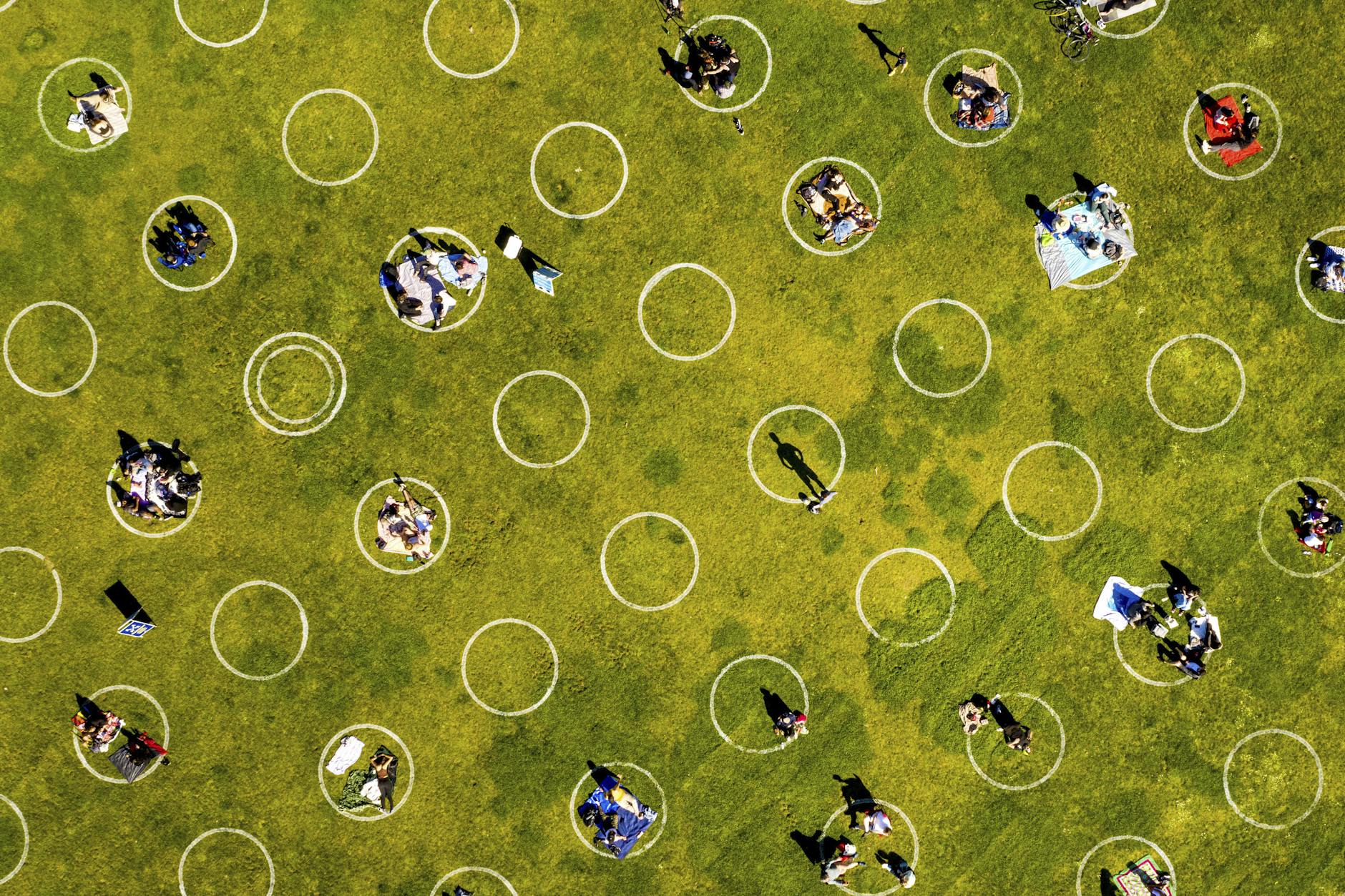 Menschen sitzen im Dolores Park innerhalb von aufgezeichneten Kreisen, die dazu beitragen sollen, die soziale Distanzierung einzuhalten und dadurch die Ausbreitung des Coronavirus zu verhindern. 