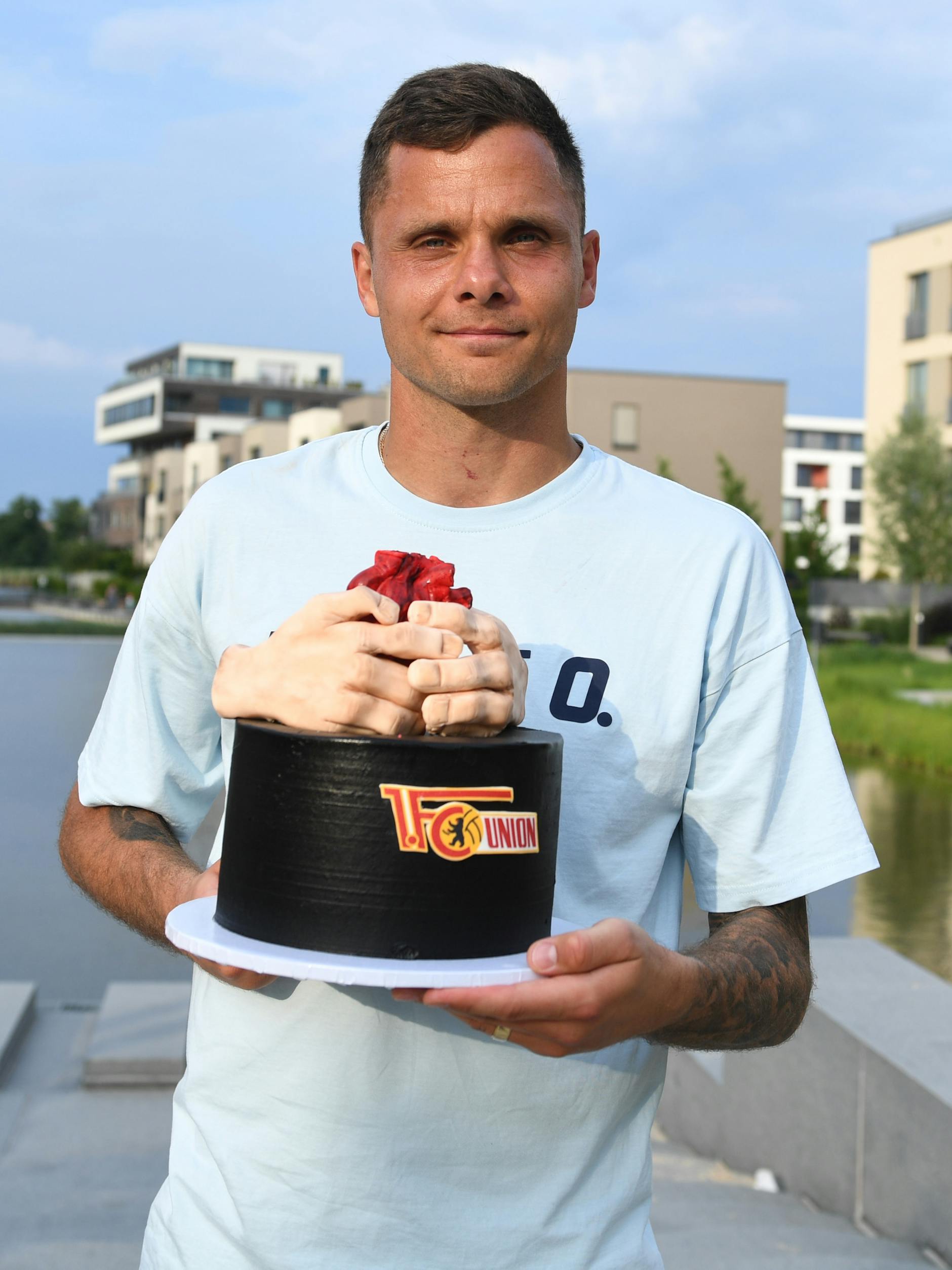 Rafal Gikiewicz (1. FC Union Berlin) zeigt die Torte, die seine Frau Ania in Grünau im Restaurant "Tous Les Jours" beim Abschiedsfest für ihren Mann organisiert hatte. 