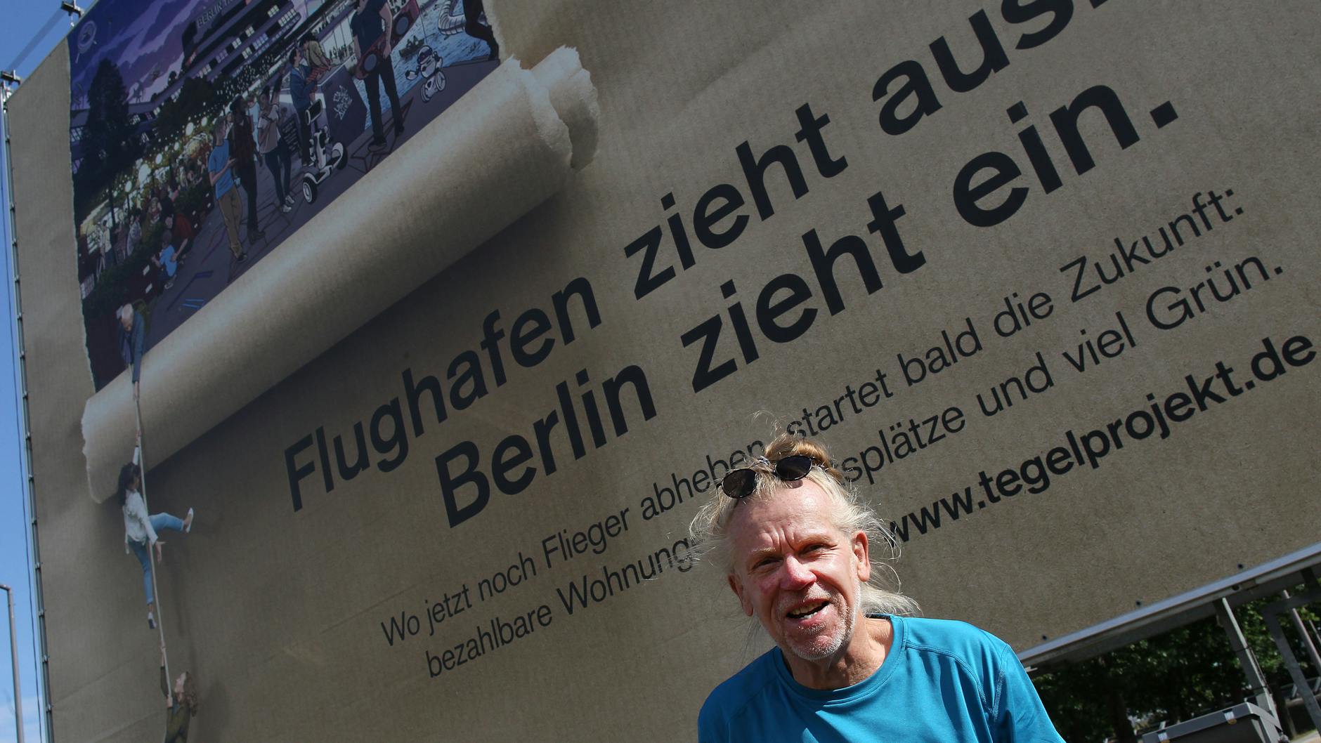 Johannes Hauenstein am Flughafen Tegel. Mit dem Plakat wirbt die Tegel Projekt GmbH für die geplante Umgestaltung des Geländes.