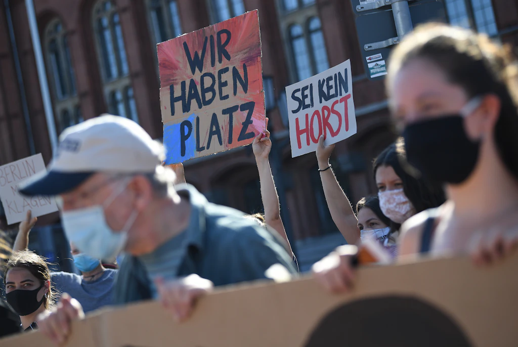 The signs say Germany has plenty of room and that you shouldn't be a 'Horst'. Nobody likes Horsts.