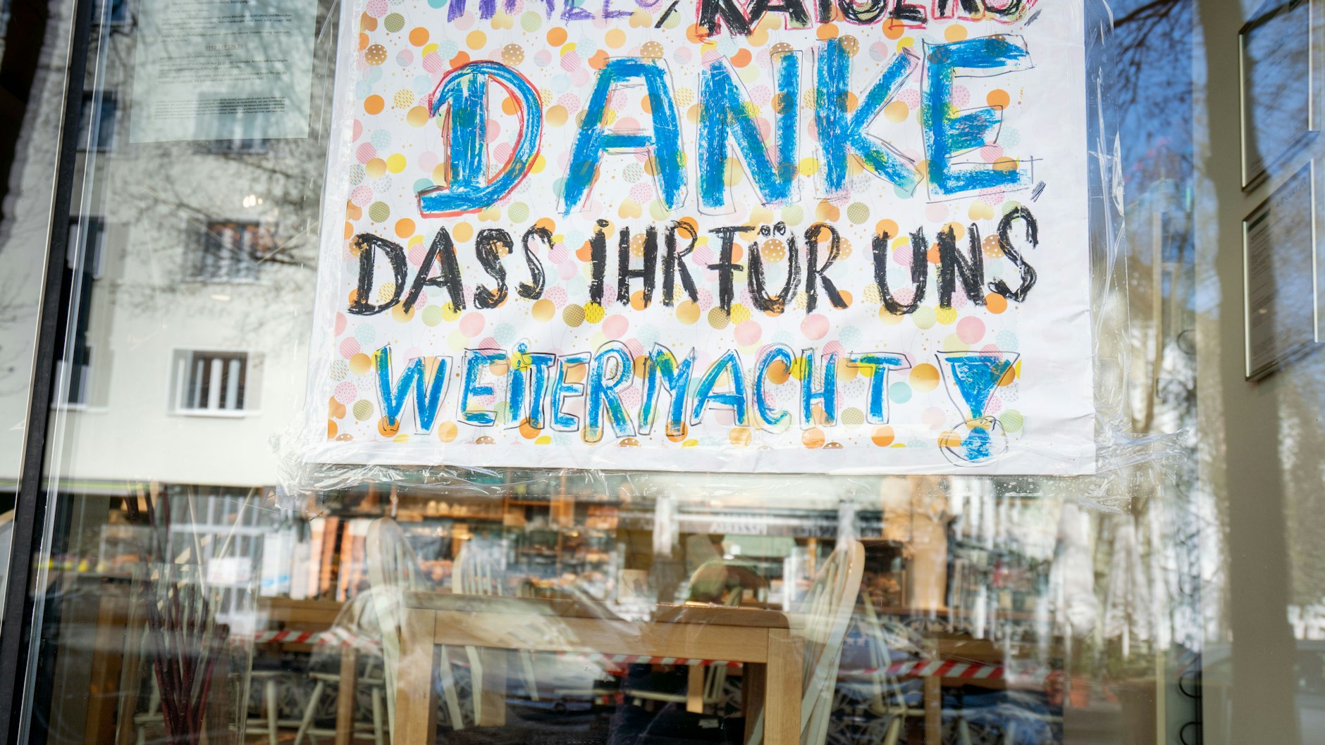 Handgemaltes Schild, das außen am Schaufenster einer geöffneten Bäckerei in Frankfurt am Main klebt.