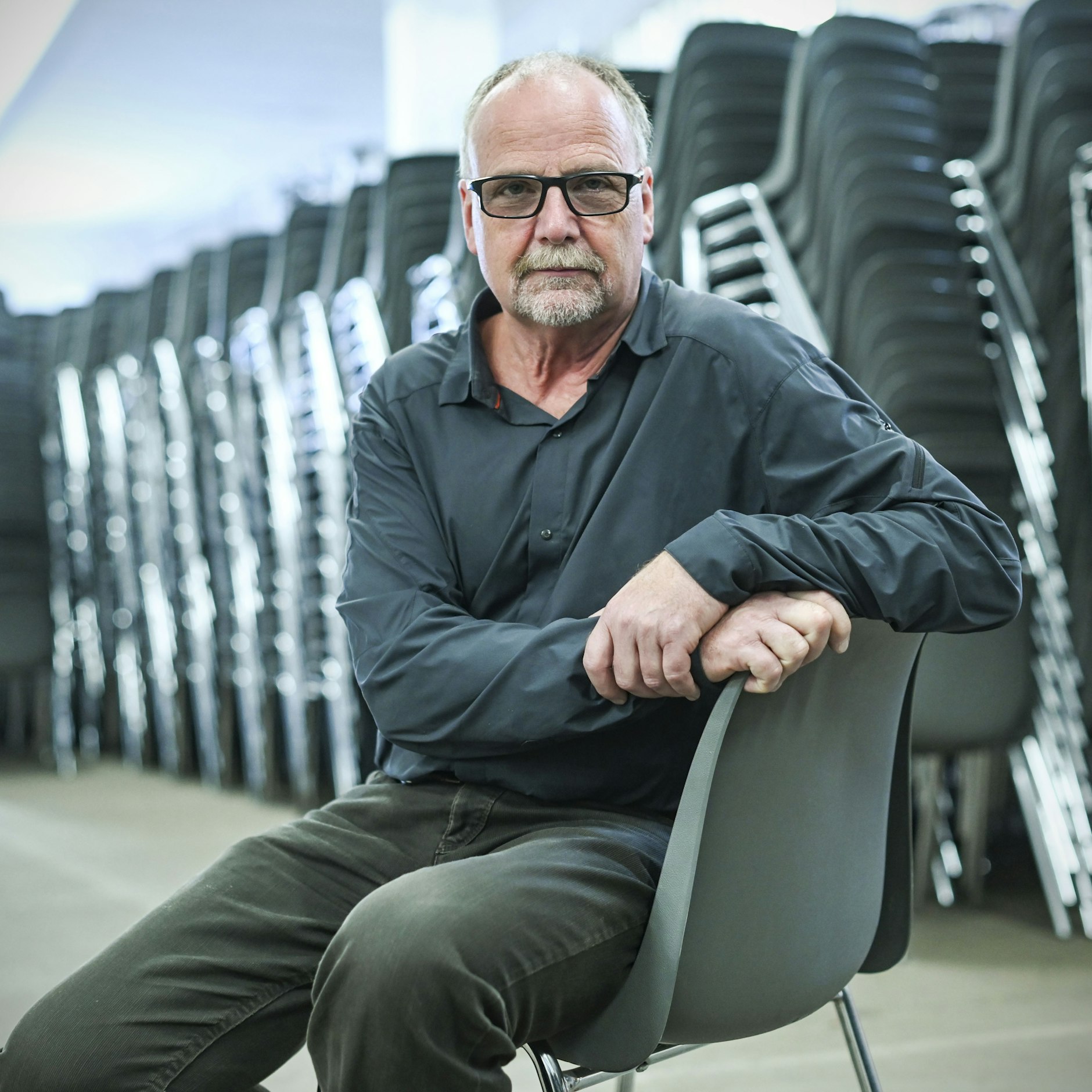 Norbert Gruchmann, Chef der Firma Expofair, auf einem klassischen Mietstuhl.