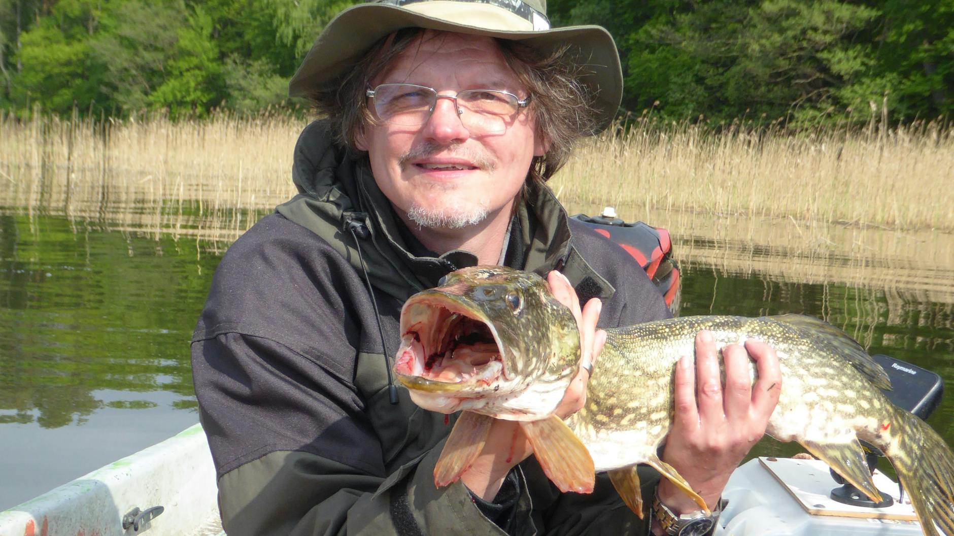 Kurier-Reporter Norbert Koch-Klaucke mit Hecht, den er in einem Brandenburger See gefangen hat.