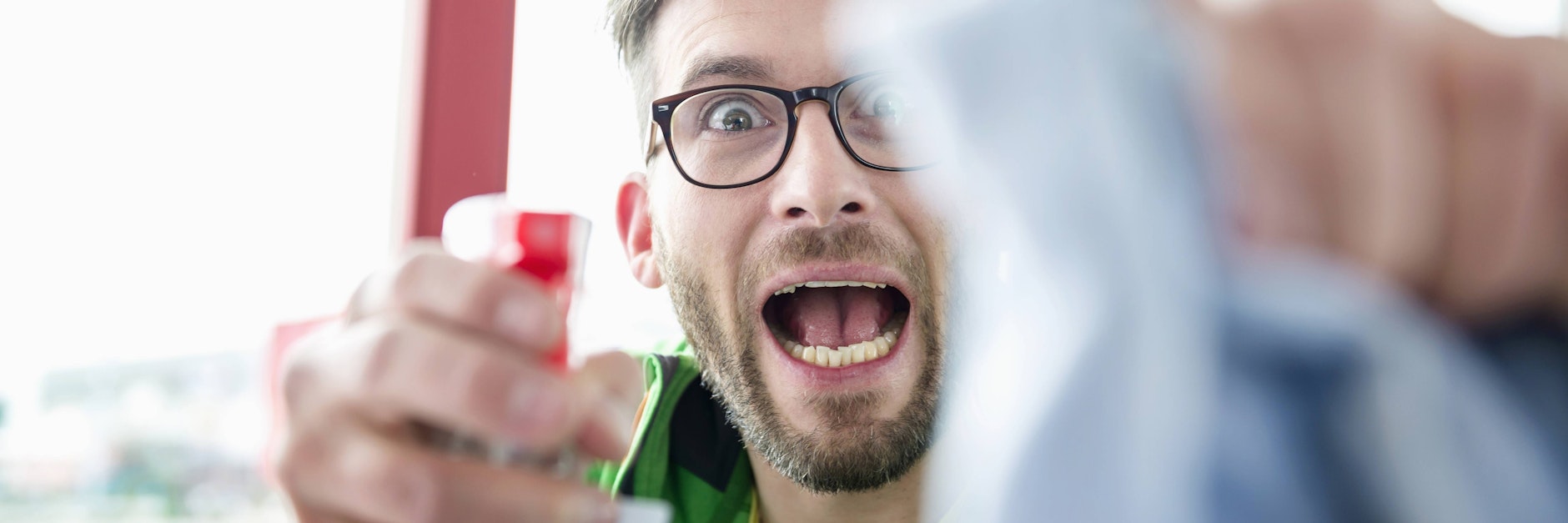 Young man holding cleaning liquid bottle and cloth mit200204568