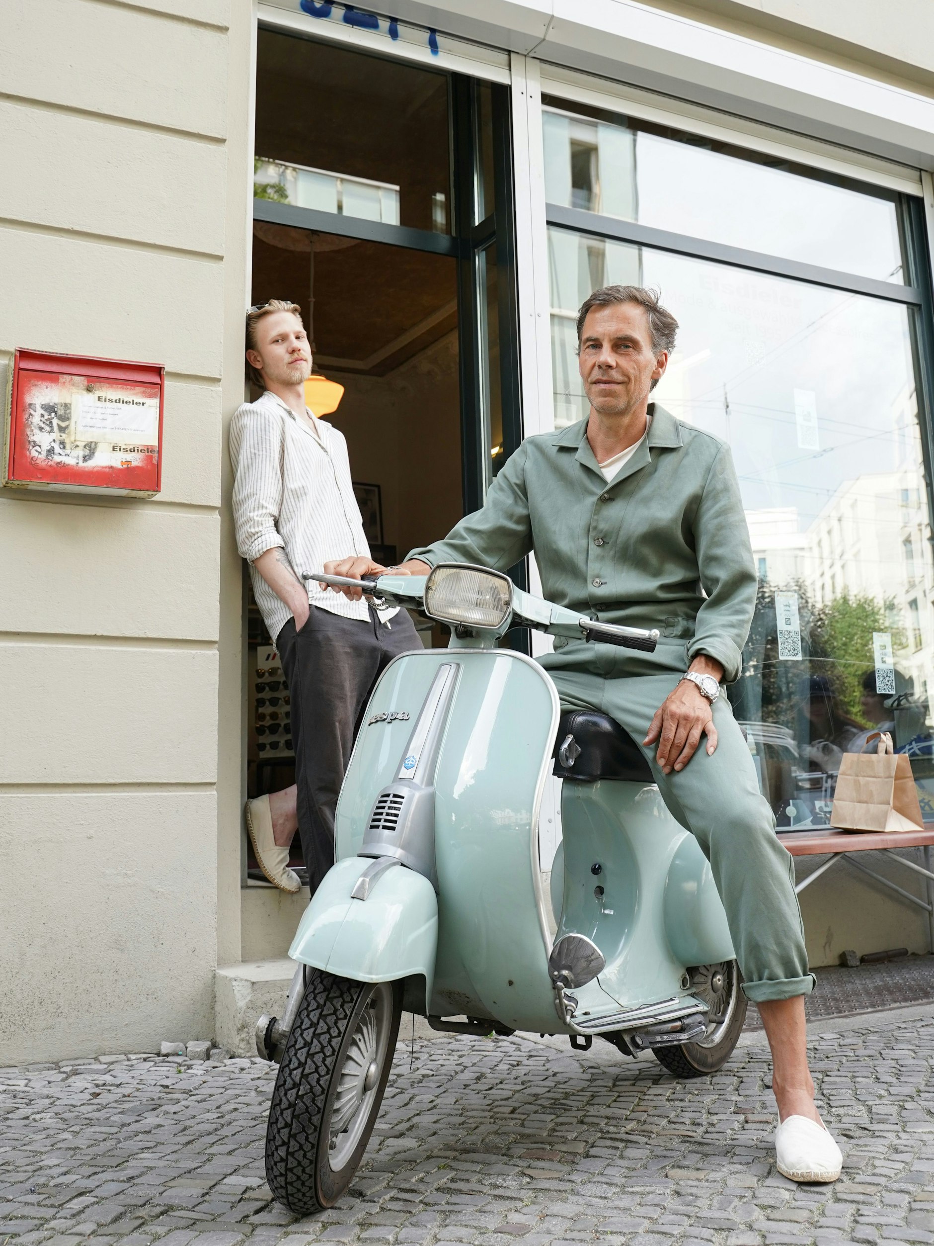 Den Streetwear-Shop Eisdieler gibt es hier schon seit 1995. Ton in Ton mit seiner Vespa trägt Betreiber Stefan einen Overall seines eigenen Labels Director’s Cut.&nbsp;