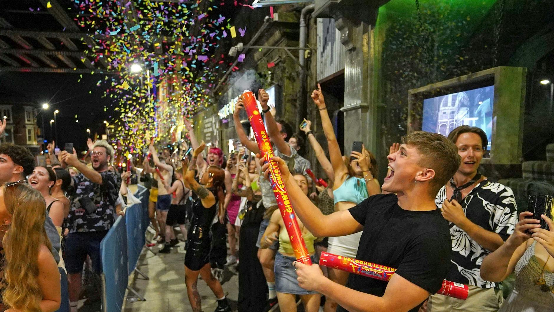 Revellers celebrate the start of "Freedom Day" at midnight on 19 July in Leeds, England.