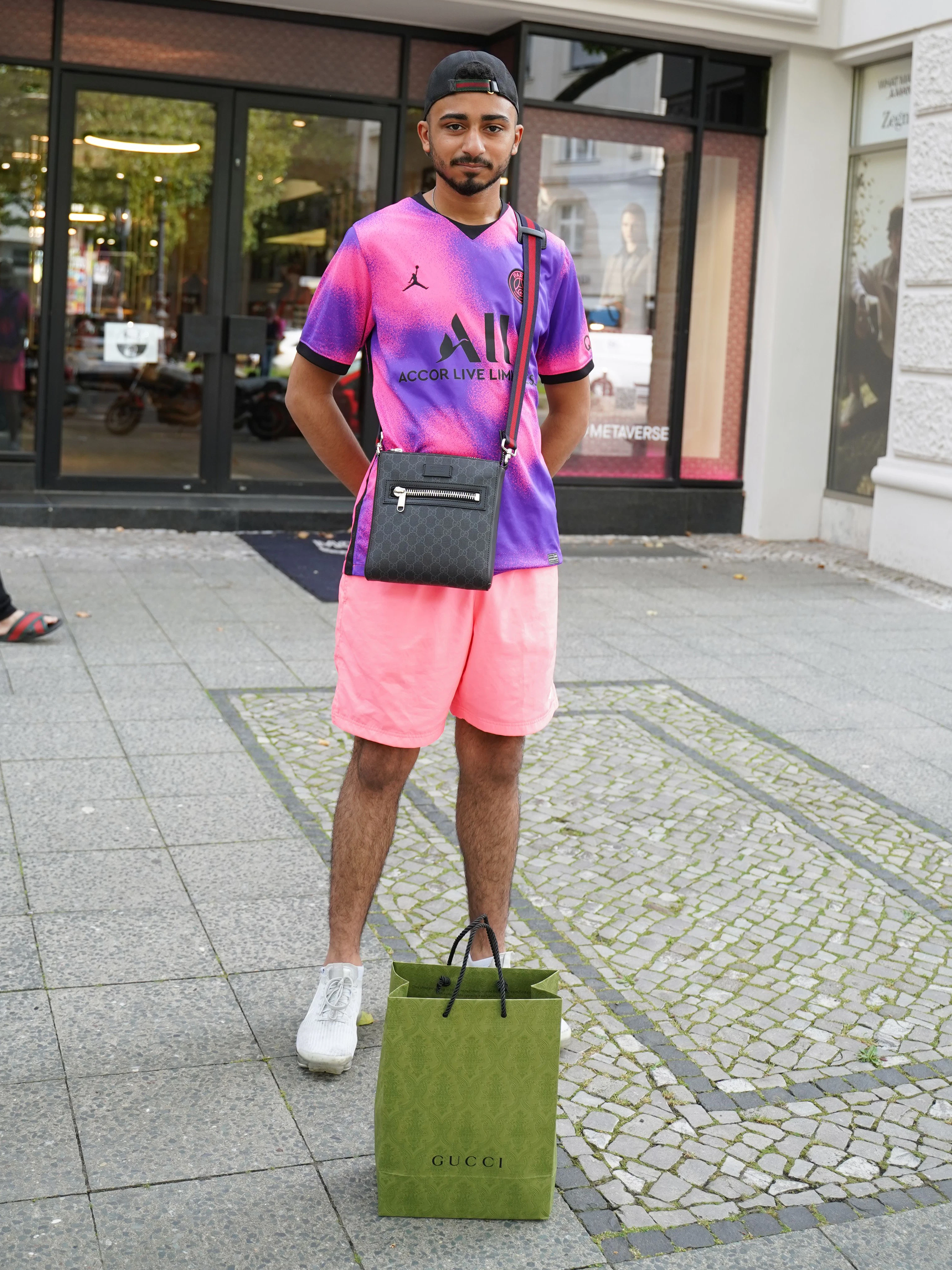 Maurice liebt Gucci, trotzdem prangert er die schlechte Qualität seiner neuen Tasche an, bei der sich kurz nach Kauf schon die Fäden lösen. „Bei einem Preis von 750 Euro kann man was anderes erwarten“, sagt er zu Recht. Zum Glück ist er insgesamt ein entspannter Typ, deswegen geht er sie jetzt eben einfach umtauschen. Zu seinem Chiller-Outfit gehören Shirt und Shorts von Nike (Jordan Paris Saint-Germain) und Nike VaporMax-Sneakers.