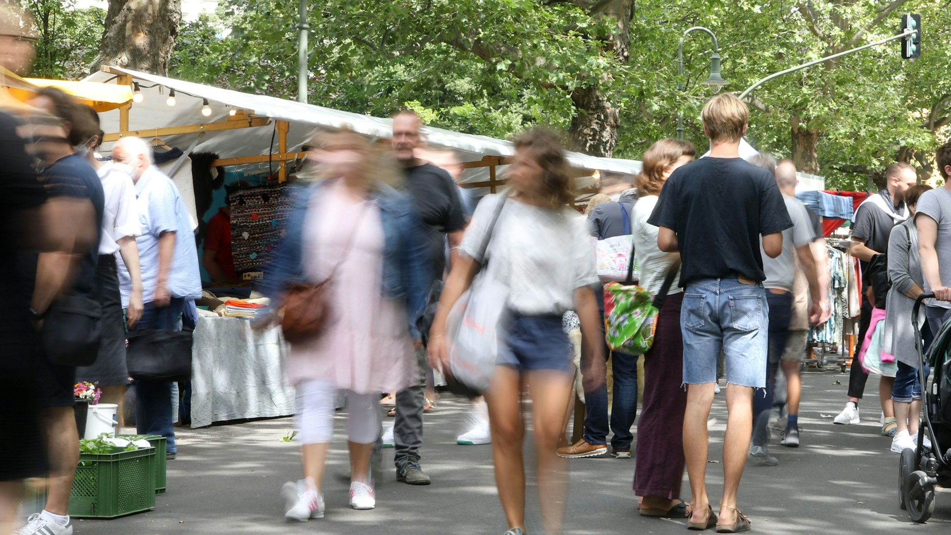 Die Corona-Inzidenz in Berlin steigt weiter. Noch genießen Menschen den Sommer wie hier auf dem Wochenmarkt am Kollwitzplatz.