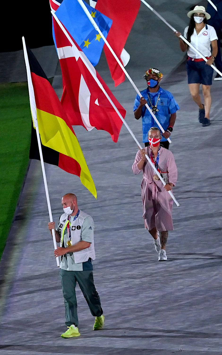 Ronald Rauhe trägt die deutsche Fahne bei der Abschlussfeier.