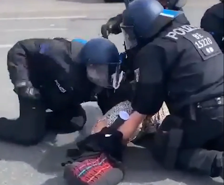 Ein Polizist schlägt auf der Straße des 17. Juni eine Frau.