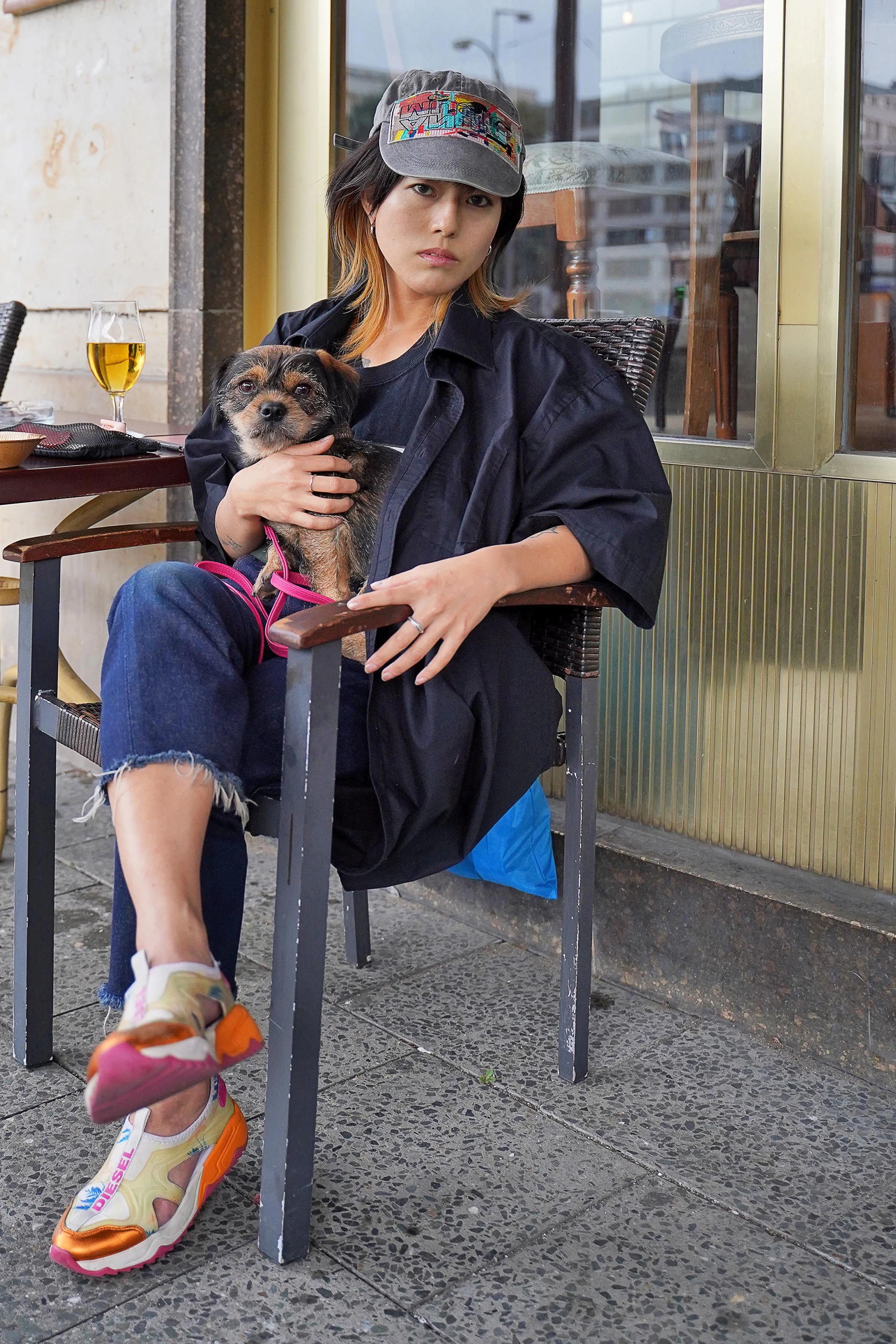 Erika kam vor vier Jahren aus Japan nach Berlin. Vor der Pandemie hatte sie Auftritte als Performance-Künstlerin im KitKatClub, nun will sie erst mal zurück in die Heimat. Sie trägt ein Cap des japanischen Streetwear-Labels Bodysong, eine Vintage-Jacke und eine abgeschnittene Levi’s-Jeans, dazu Diesel-Sneakers.