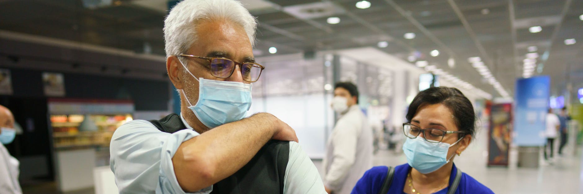 Mahmud Sadjadi aus dem Ort Berod im Westerwald demonstriert am frühen Morgen auf dem Frankfurter Flughafen, wie in Kabul vor seiner Evakuierung nach Deutschland ein Mann durch einen Streifschuss der Taliban verletzt wurde. Rechts seine Tochter Zainab.