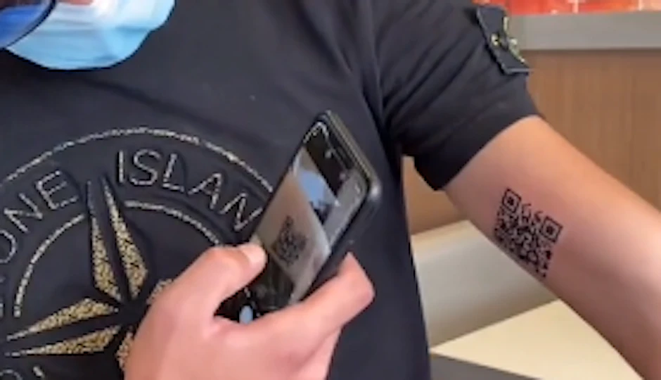 Andrea Colonnetta lässt sein Tatto mit dem Impf-QR-Code scannen.