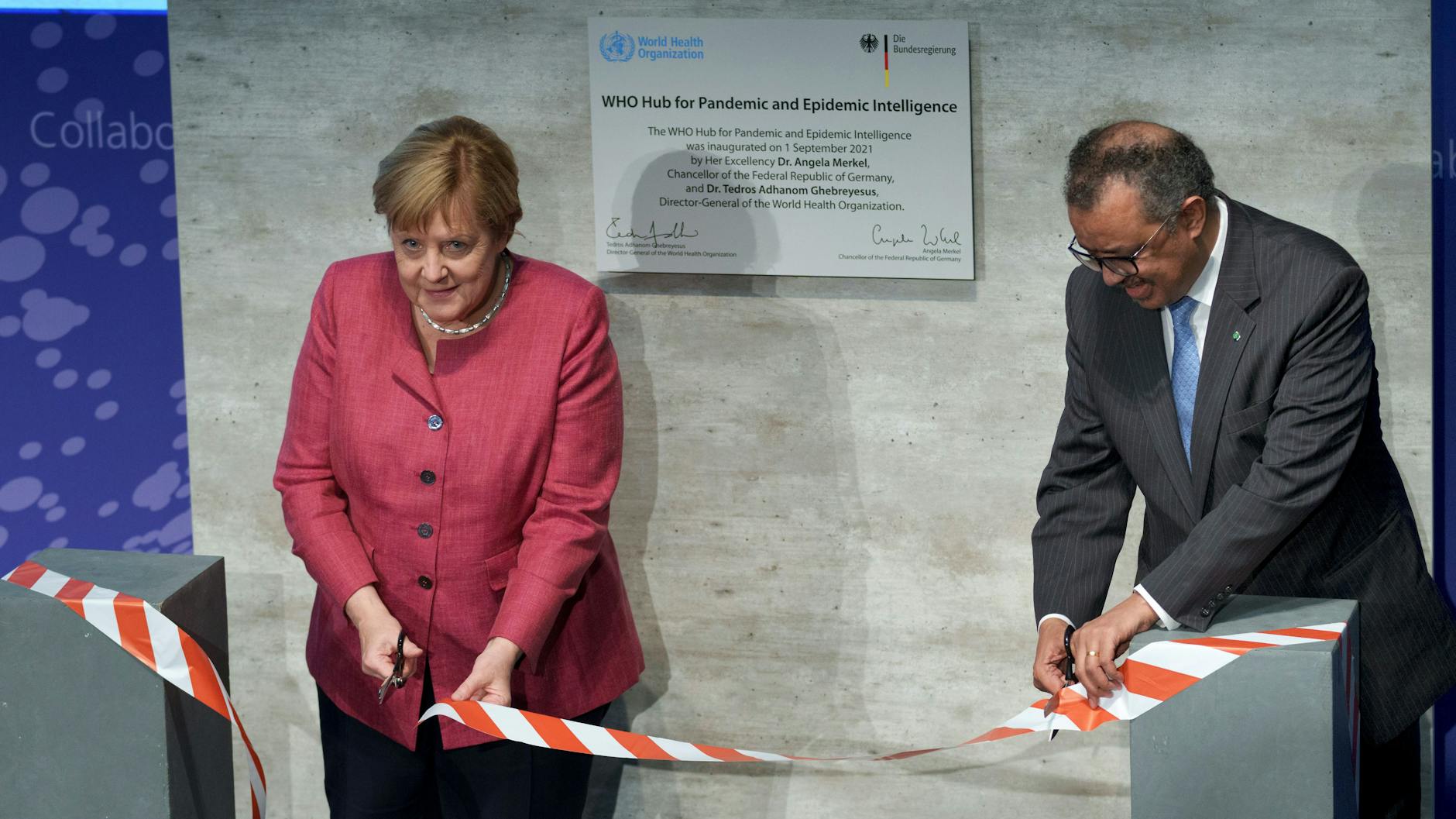 Tedros Adhanom Ghebreyesus, Generaldirektor der Weltgesundheitsorganisation (WHO), und Bundeskanzlerin Angela Merkel (CDU) durchschneiden symbolisch ein Band bei der Einweihungszeremonie des „WHO Hub for Pandemic and Epidemic Intelligence“. 