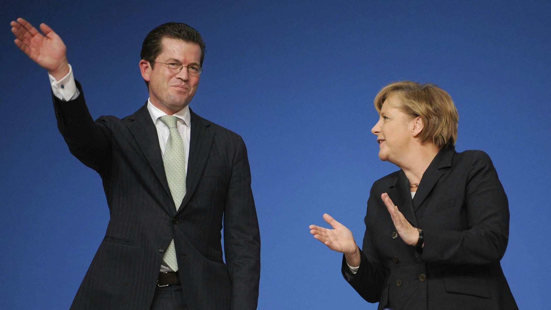 CDU-Parteitag im November 2010: Karl-Theodor zu Guttenberg (CSU) winkt, Angela Merkel klatscht.