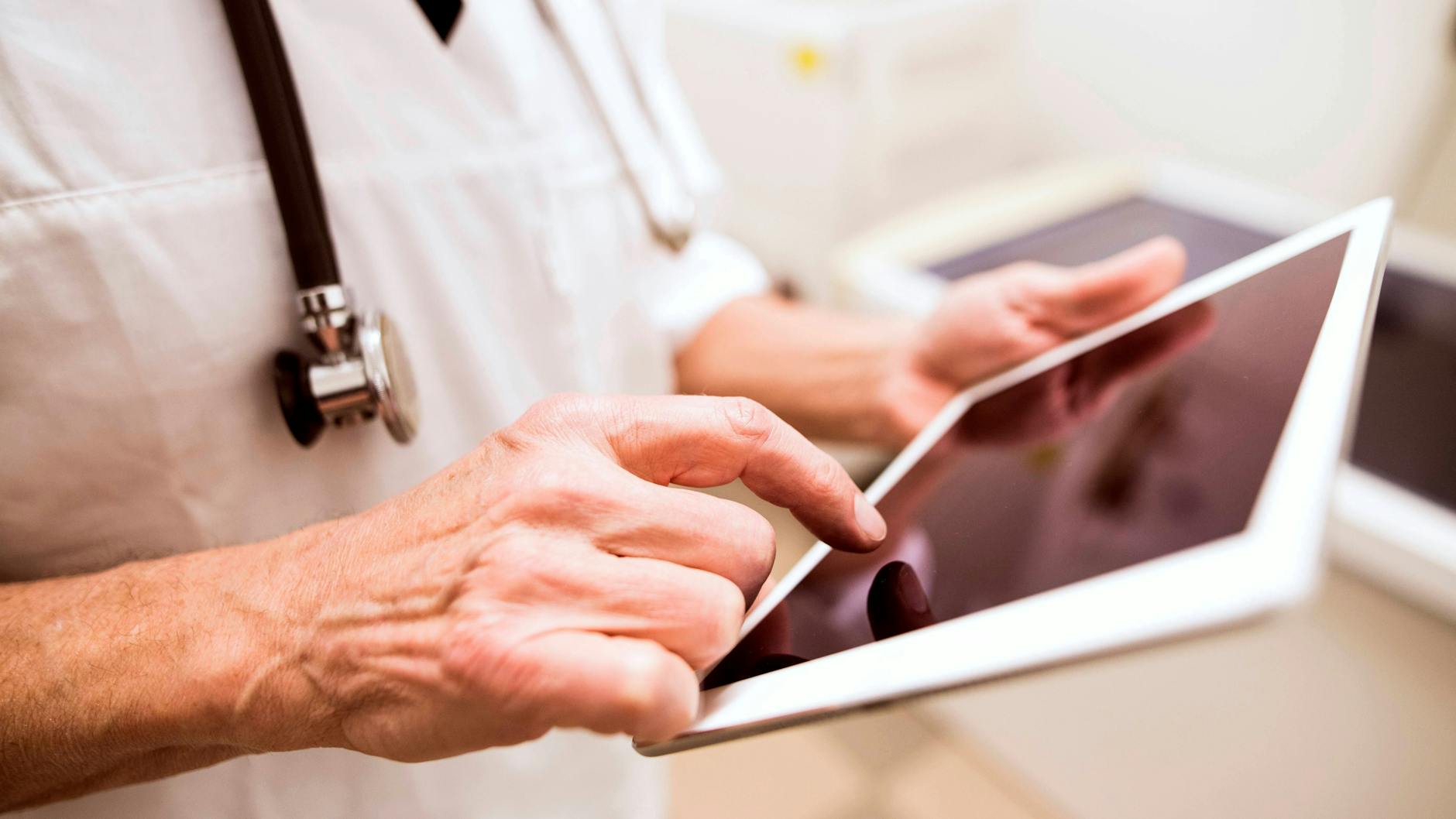 Ein Arzt mit Tablet-Computer (Archivbild).