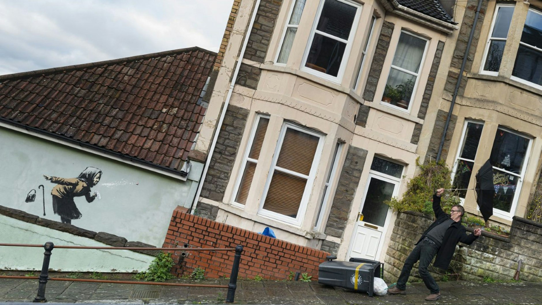 Das Graffiti an der Hauswand in Bristol mit der stark niesenden Frau wird von Fans und Passanten für lustige Fotoaufnahmen genutzt.