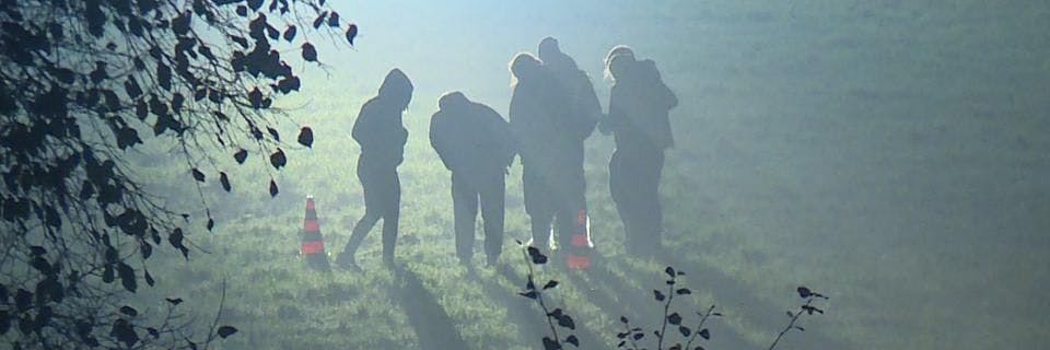 Mordermittler und Kriminaltechniker stehen im November auf einem Feld an der Schönerlinder Straße, wo Knochenteile des ermordeten Stefan T. gefunden wurden. 