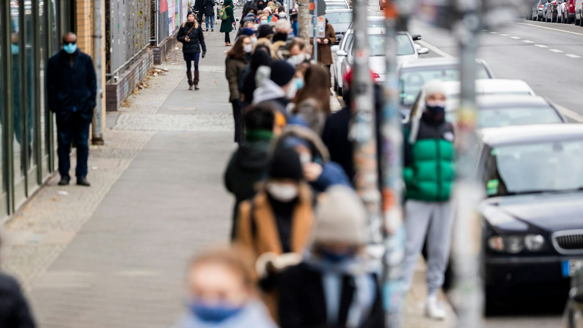 Menschen stehen vor Weihnachten auf der Köpenicker Straße Schlange, um in das Schnelltestzentrum vom Fetisch-Klub Kitkat zu kommen.