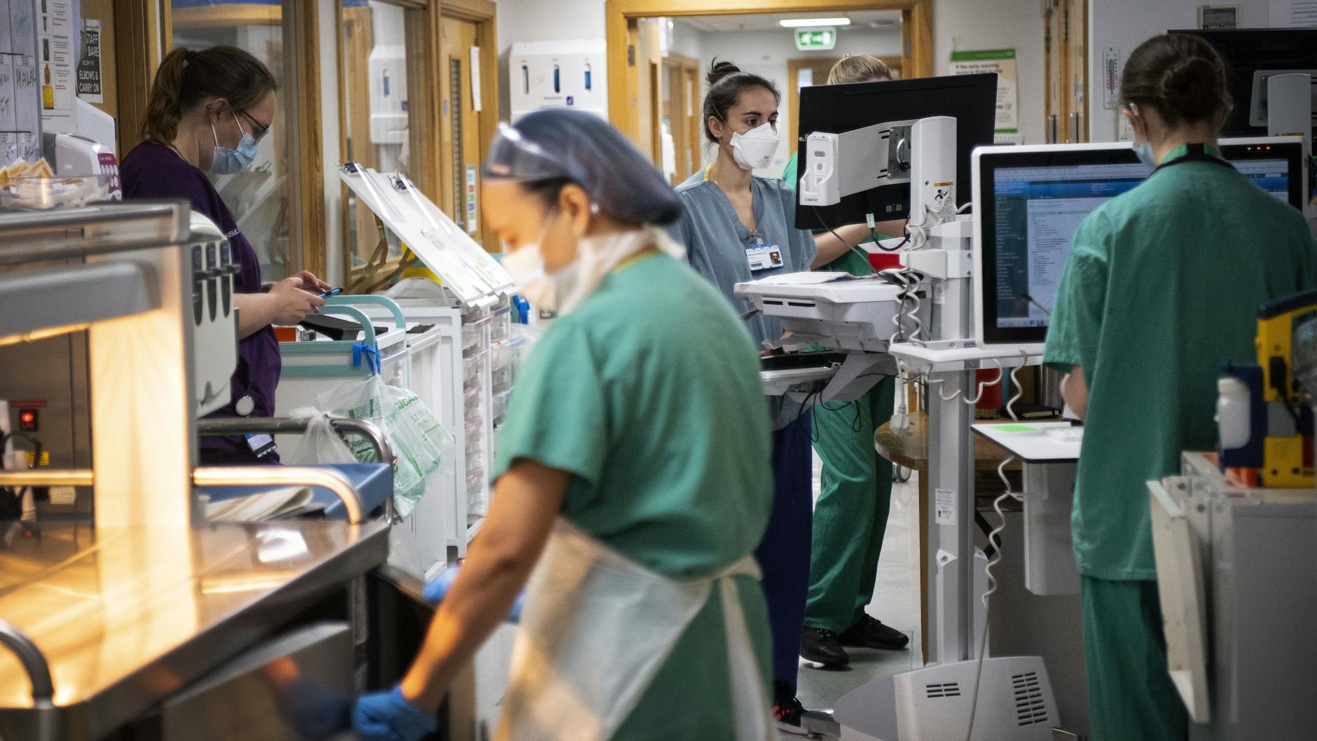Nurses working in a corridor in an intensive care ward.