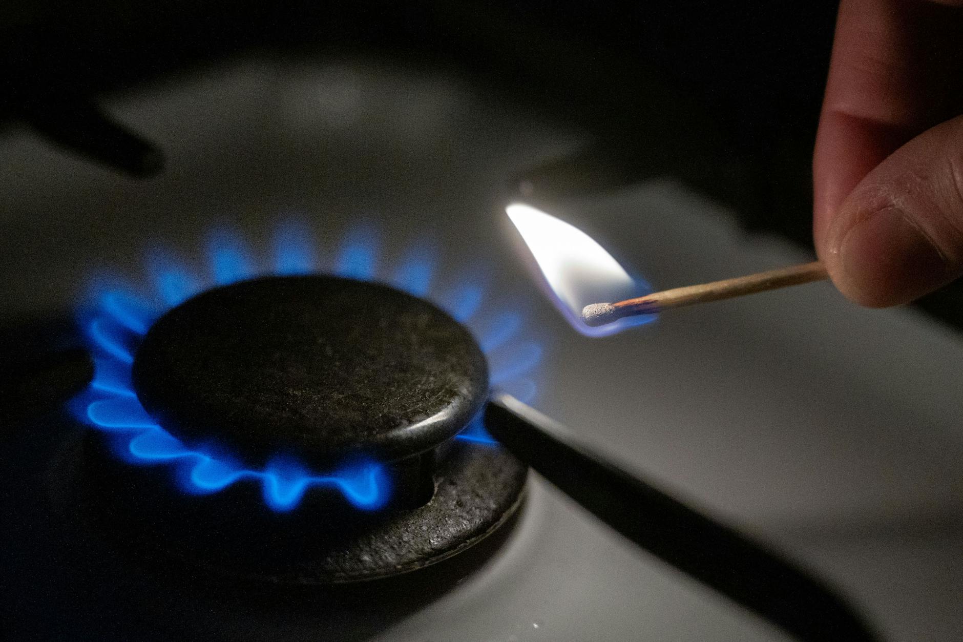 Kann teuer werden: Eine Gasflamme wird auf einem Küchenherd mit einem Streichholz entzündet (Symbolbild). 