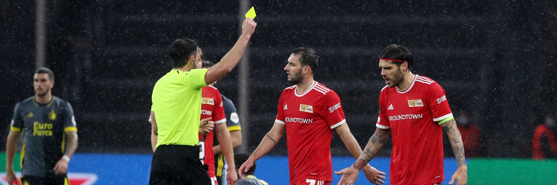 Der polnische Schiedsrichter Daniel Stefanski zeigt Christopher Trimmel (r.) erst Gelb und dann Rot. Levin Öztunali (M.) versucht vergeblich, ihn davon abzubringen.