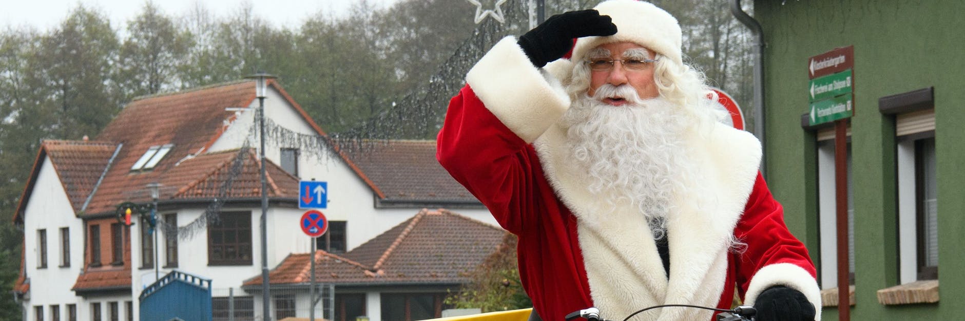 Der Weihnachtsmann fährt auf einem Elektro-Fahrrad der Deutschen Post zum Weihnachtspostamt.