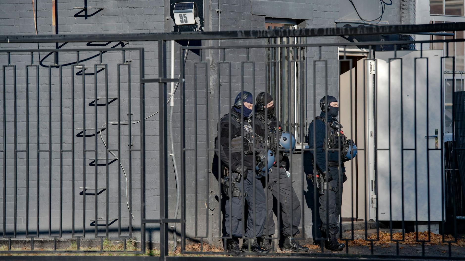 Polizisten stehen bei einer Razzia gegen Drogendealer vor einem Bürogebäude (Symbolbild).