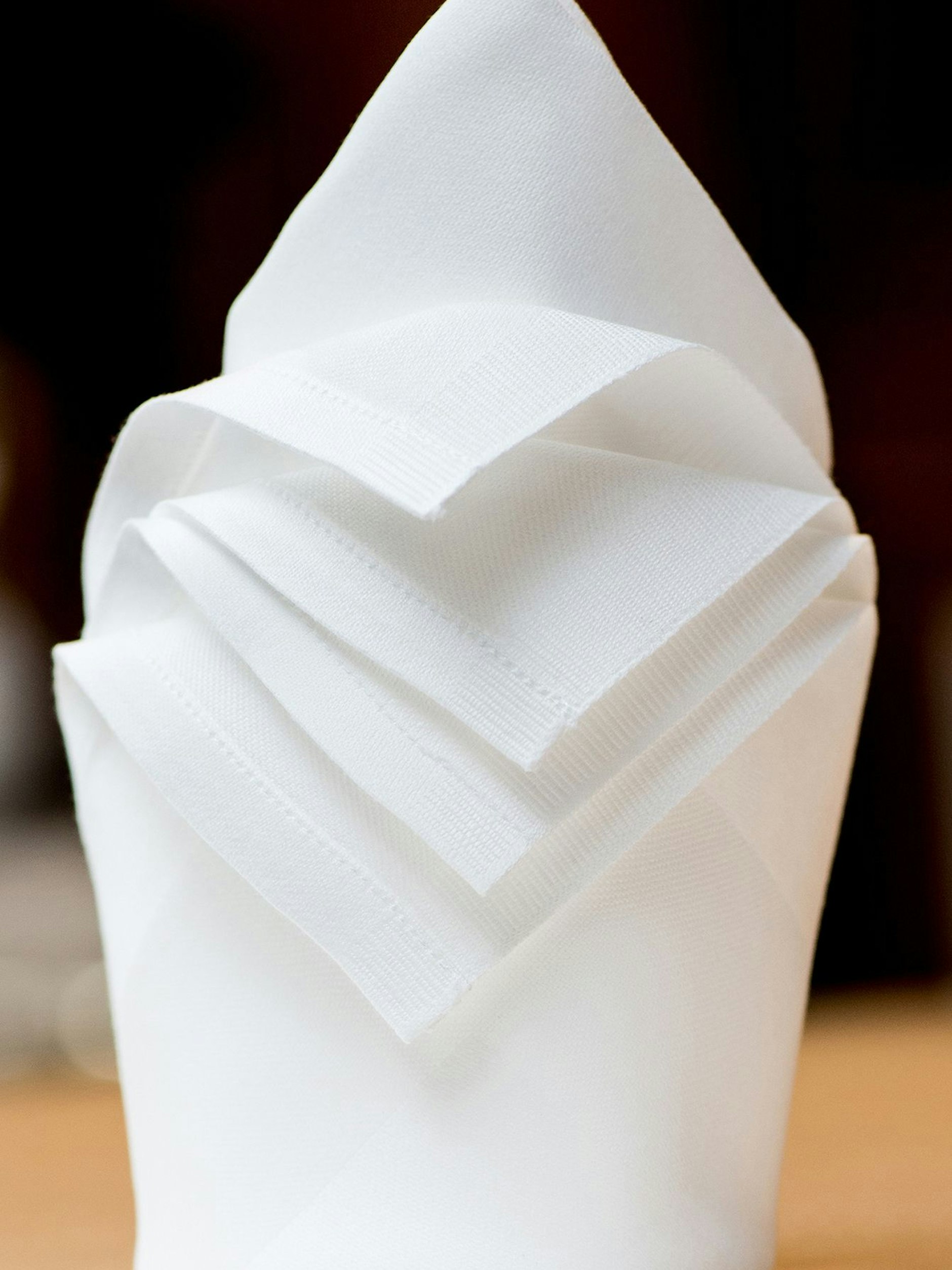 Der Zylinder mit den umgeklappten Ecken passt zu einer locker eingedeckten Festtafel. Die Menükarte kann hinten in die Serviette gesteckt werden.