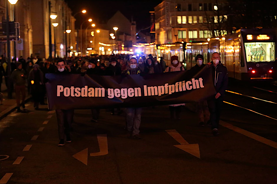 Demonstranten gehen am Montagabend mit einem Banner über die Friedrich-Ebert-Straße.