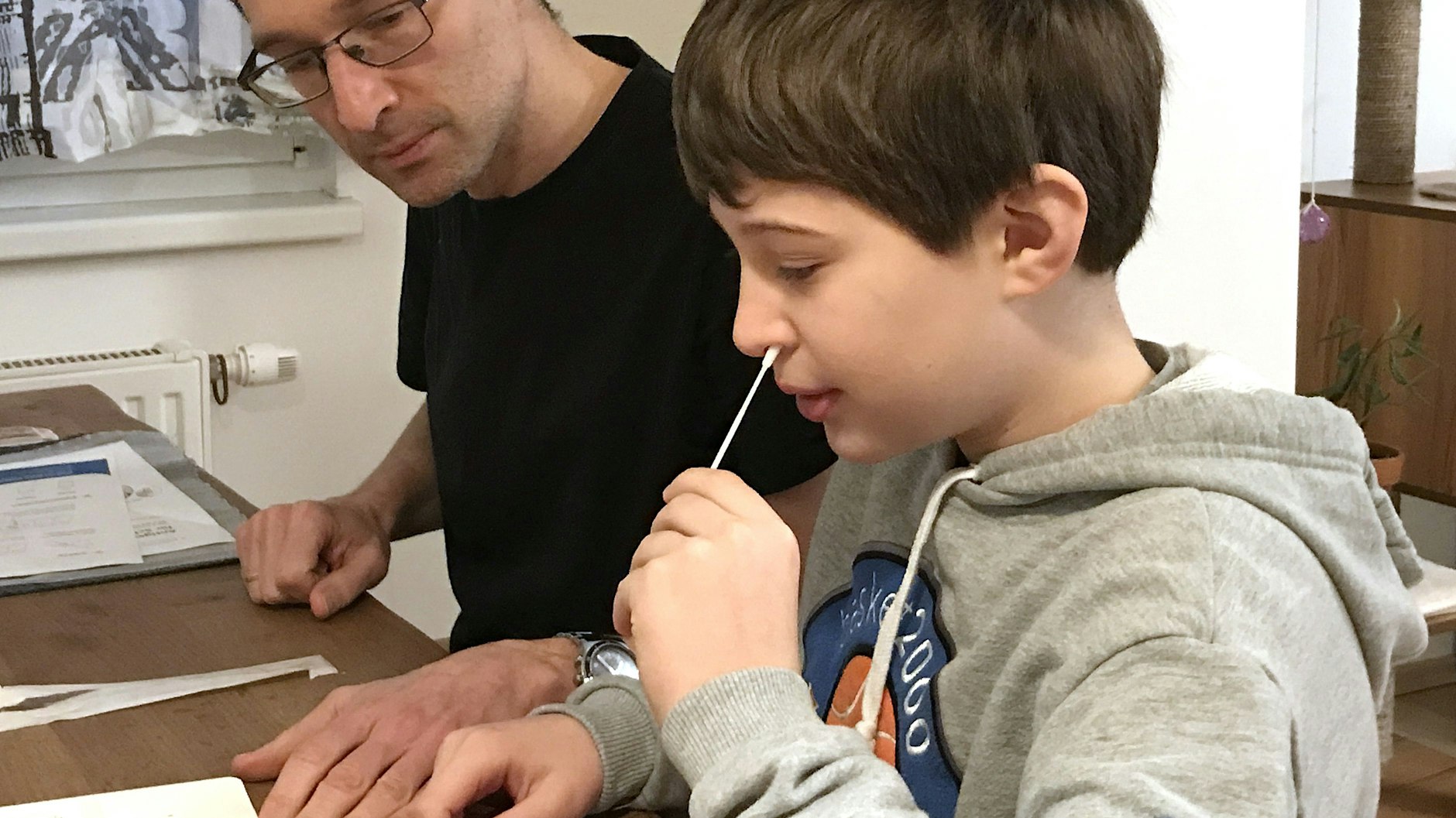 Tim (9) aus Österreich führt unter Aufsicht seines Vaters einen Selbsttest durch. Diese sind im Nachbarland schon längst auf dem Markt und auch an den Schulen im Einsatz.