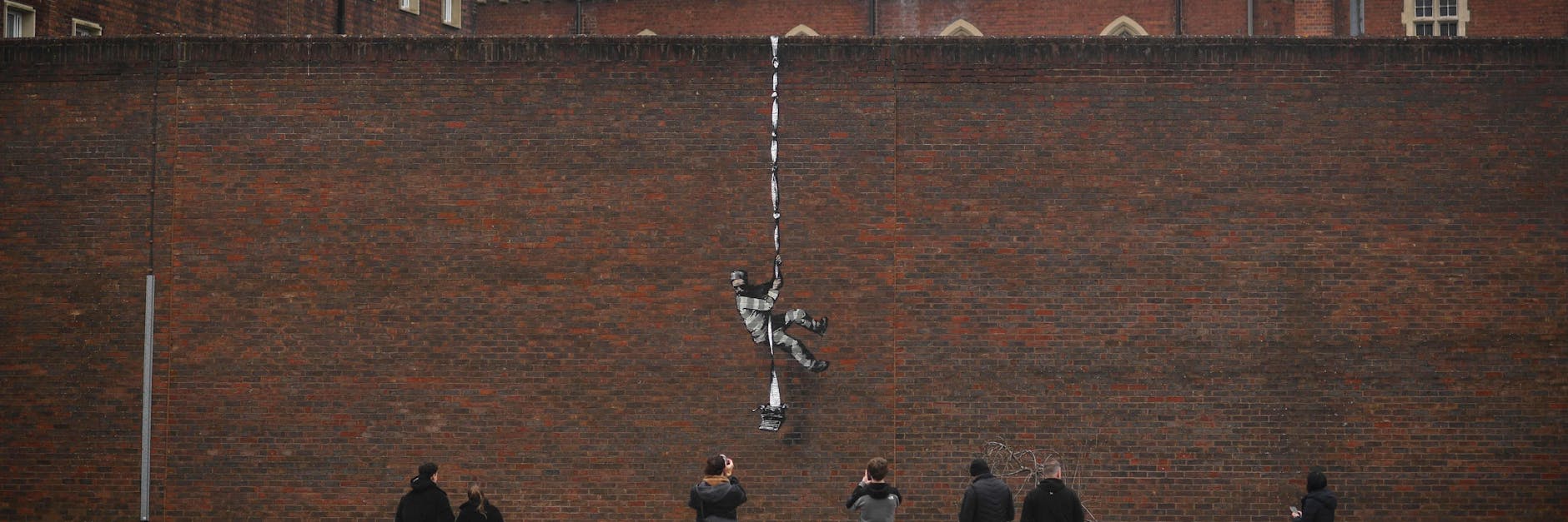 Banksys neuestes Werk an der Mauer eines ehemaligen Gefängnisses. Ein Häftling bricht mit seiner Schreibmaschine aus.