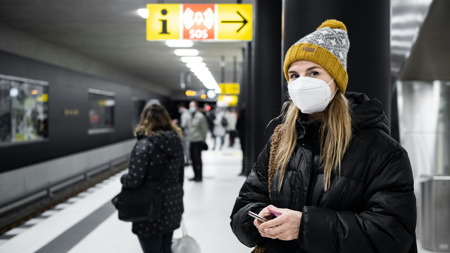 Die Maske ist schon okay. Aber das Telefon sollte in der Tasche bleiben. Fahrgäste im neuen U-Bahnhof Unter den Linden in Mitte.