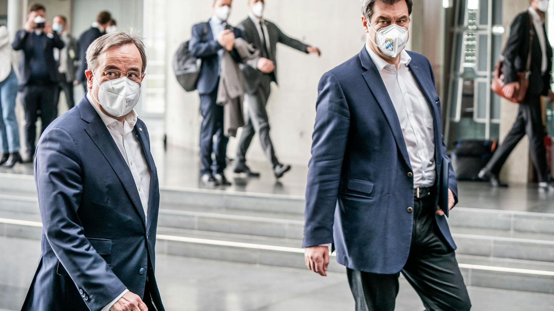 Laschet left, Söder right. No word on where the masks came from.