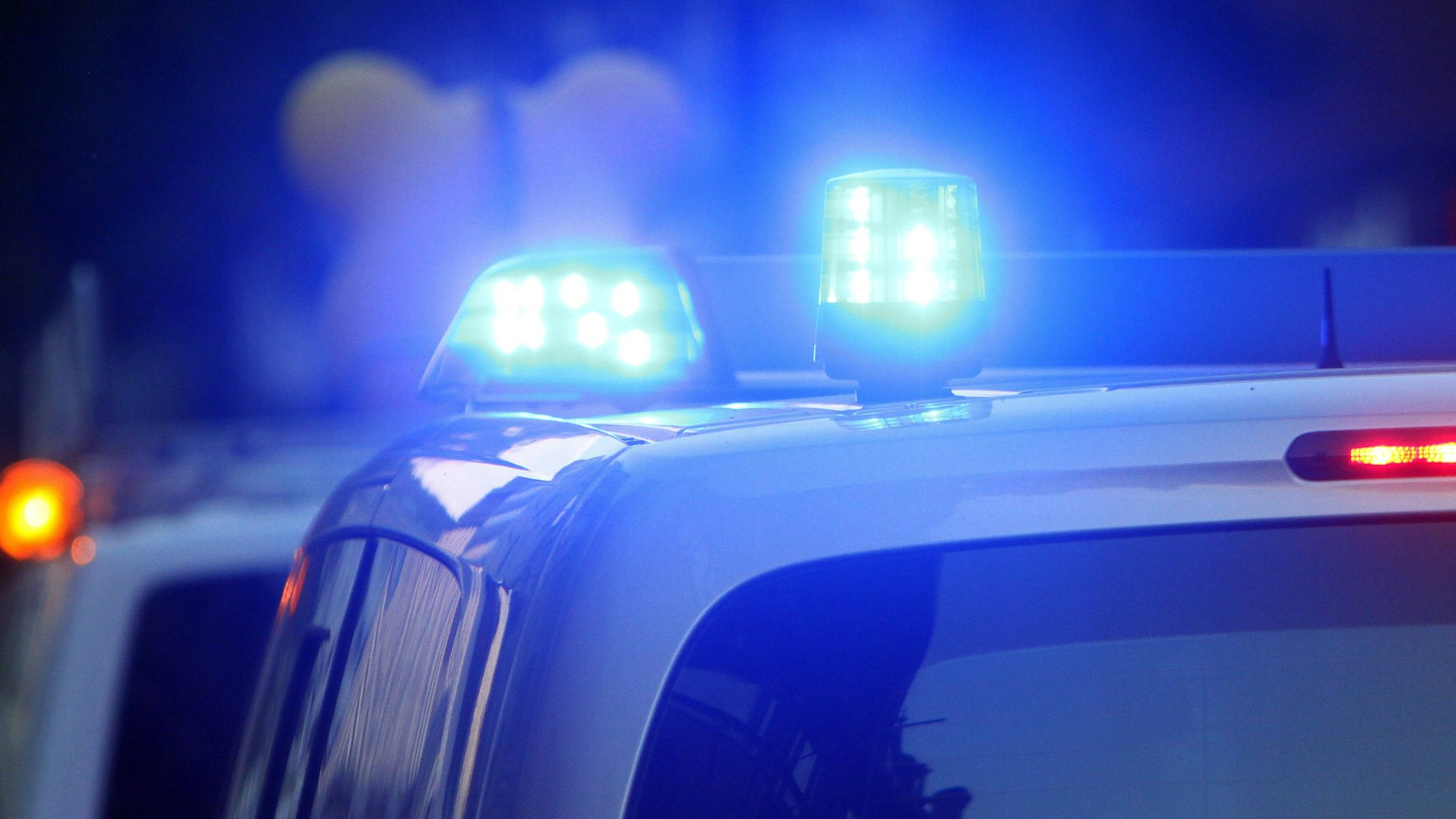 Einsatzwagen der Polizei fahren mit Blaulicht zu einer Unfallstelle (Symbolbild).