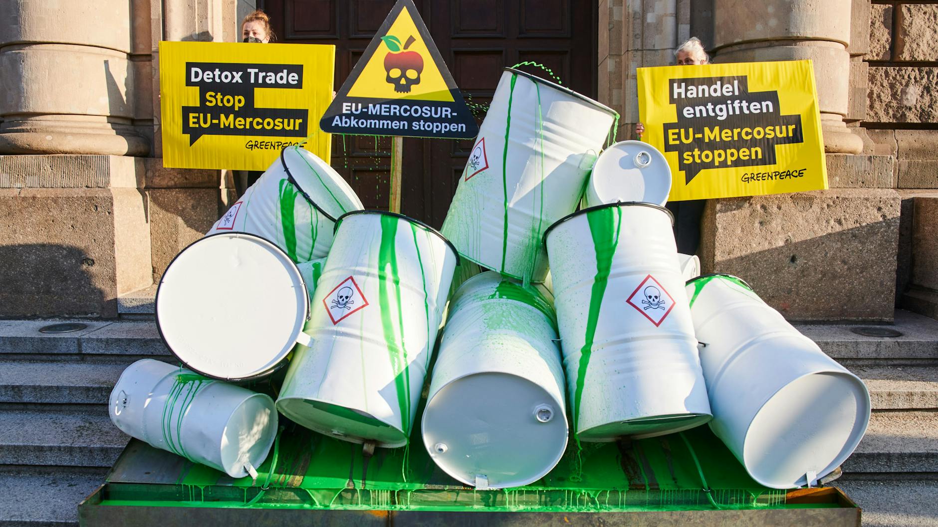 Fässer, die symbolisch als Giftfässer mit grüner Farbe angemalt wurden, stehen bei einer Greenpeace-Aktion vor dem Wirtschaftsministerium in Berlin.