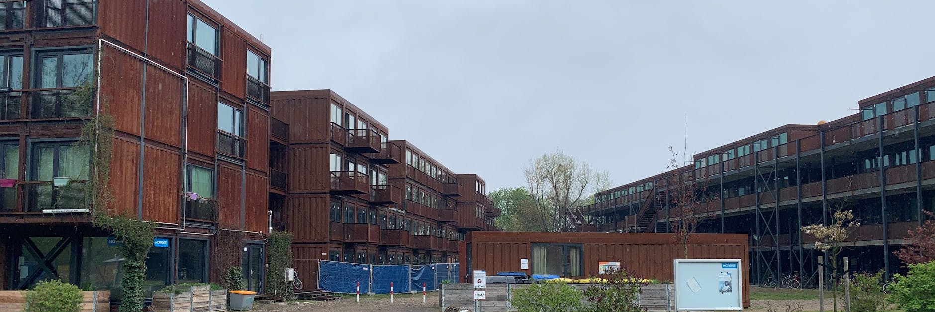 Das Studentendorf mit seinen gewollt rostigen Fassaden an der Eichbuschallee: Der Teil hinter dem mit blauen Planen verhängten Bauzaun steht leer und wird auch abgerissen.