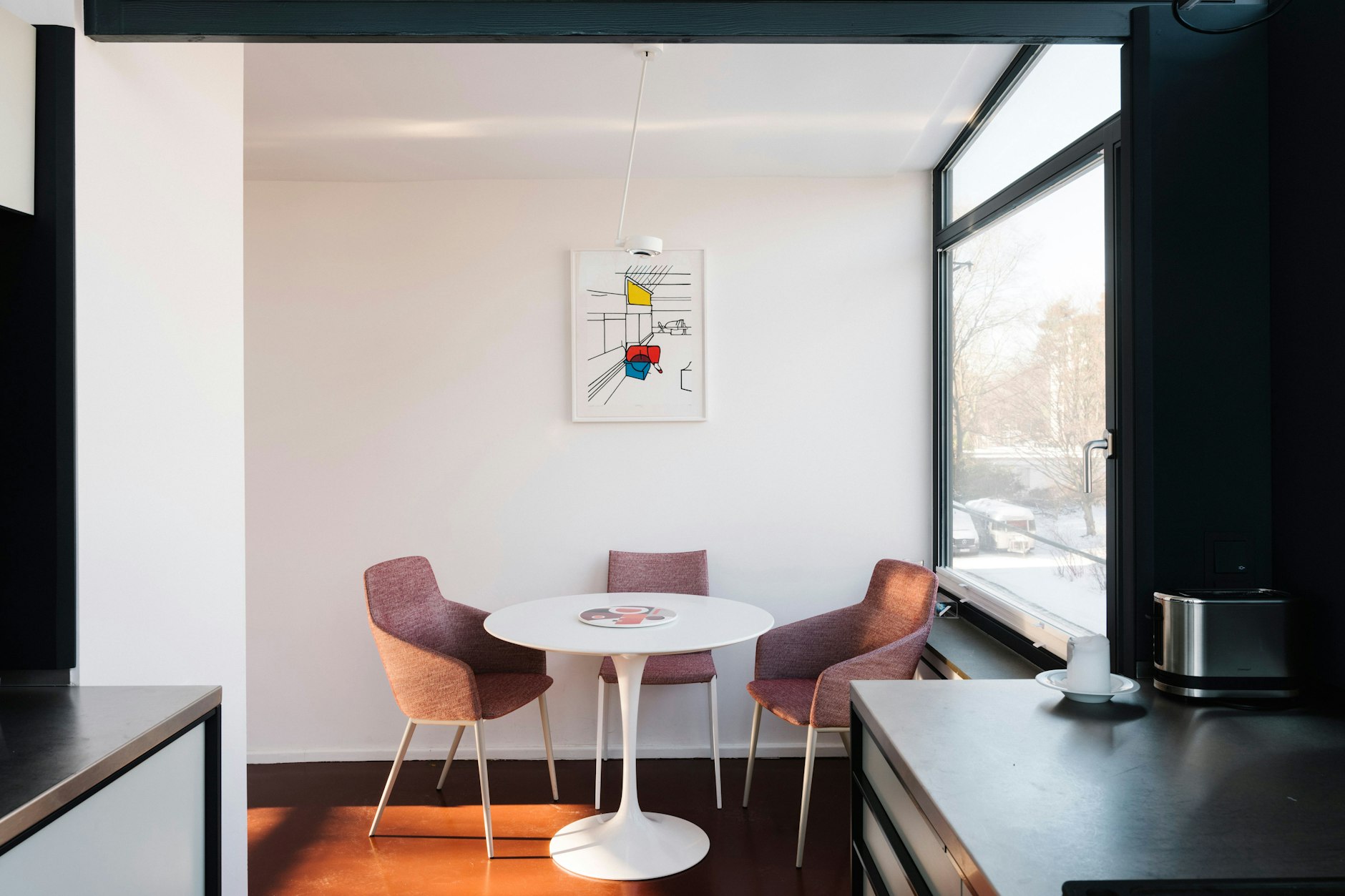 Ein Platz unter der Kunst: Das Kunstwerk im hellen Essbereich stammt von Valerio Adami.