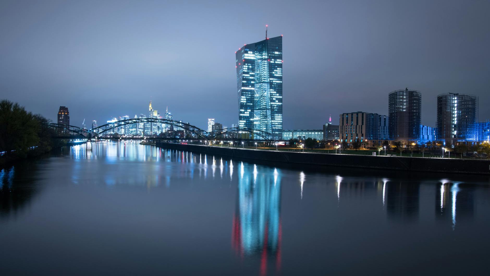 Die Lichter der Bankenskyline von Frankfurt und der EZB leuchten in der Nacht.