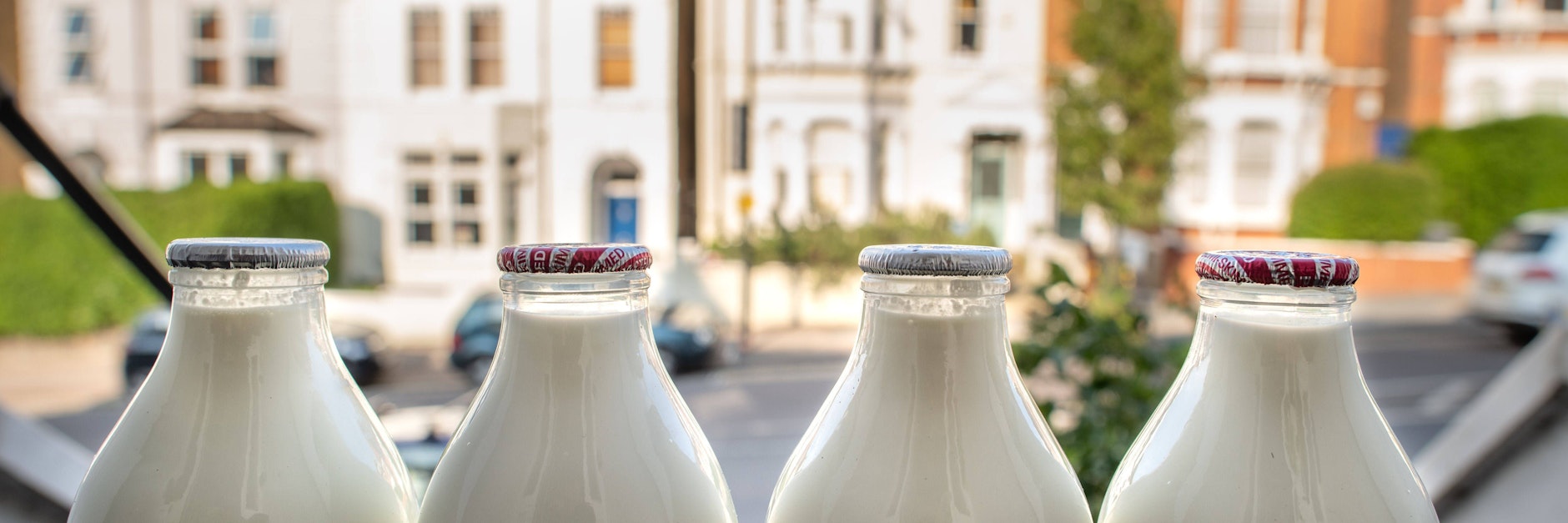 Die vom Milchmann gelieferten Milchflaschen stehen vor einem Hauseingang in London