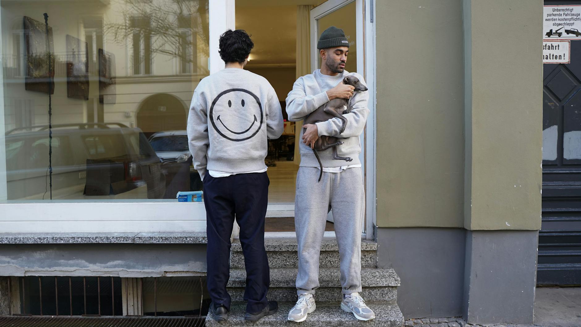 Ali mit guter Laune auf dem Rücken und Jonas mit Hund Schmitti im Arm. So wird zwischen Noto-Area und Hauptbahnhof in Berlin Mitte gearbeitet.