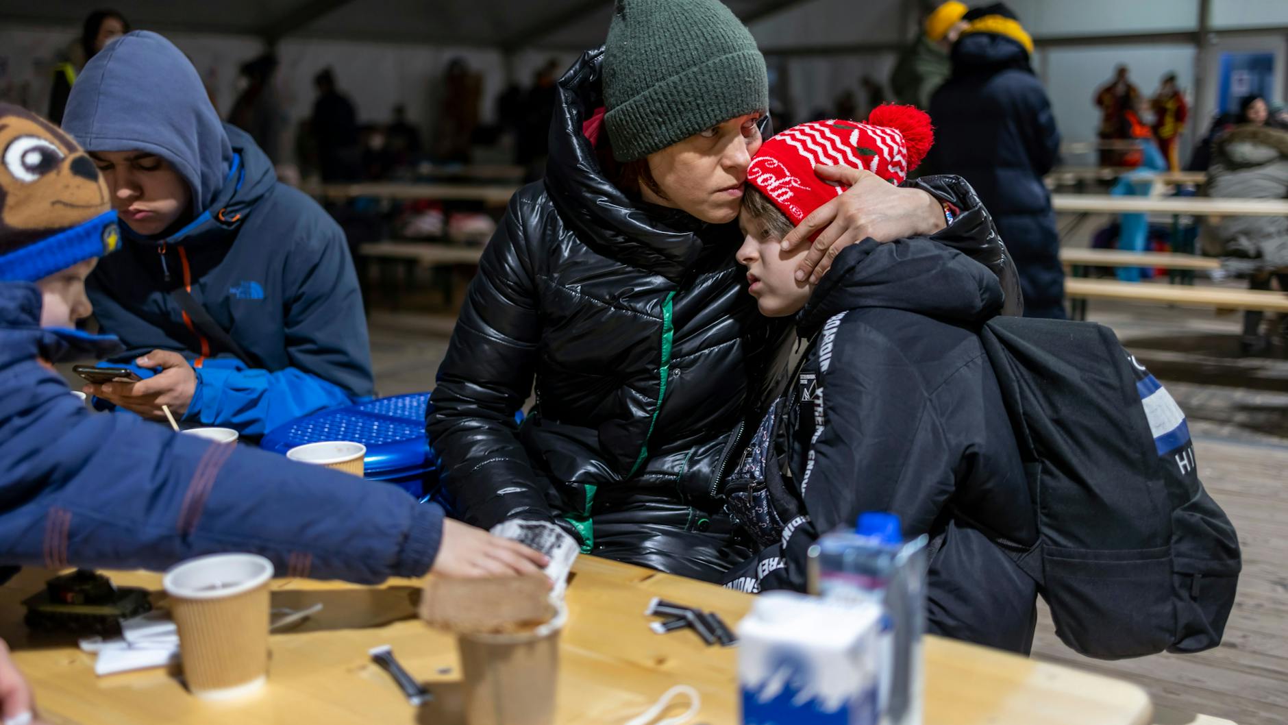 Larissa aus dem ukrainischen Bucha sitzt mit ihrer Tante und deren Söhnen in einem Zelt für Geflüchtete aus der Ukraine vor dem Hauptbahnhof.